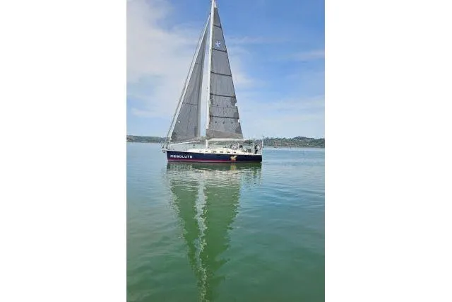 Resolute Yacht Photos Pics Sailboat "Blue Jacket 40" on calm water, 2015 model, clear sky background.