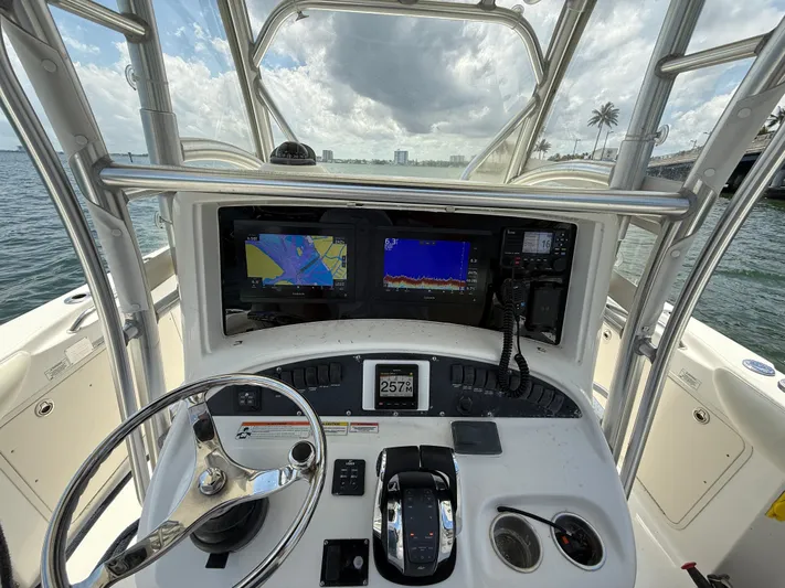  Yacht Photos Pics 2008 Boston Whaler 320 Outrage helm with navigation screens and controls, ocean view.