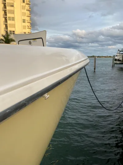 Yacht Photos Pics 2008 Boston Whaler 320 Outrage docked by waterfront building.