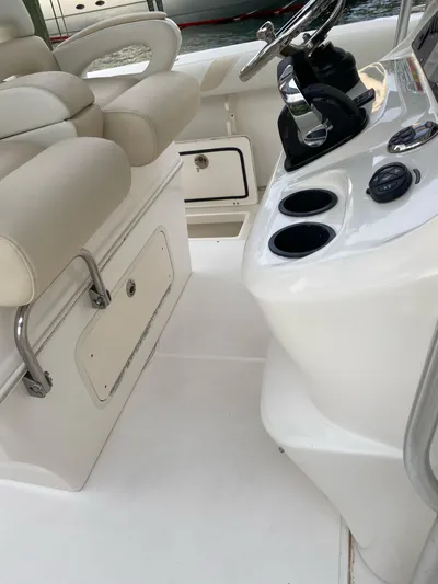  Yacht Photos Pics 2008 Boston Whaler 320 Outrage boat interior with helm and seating area.