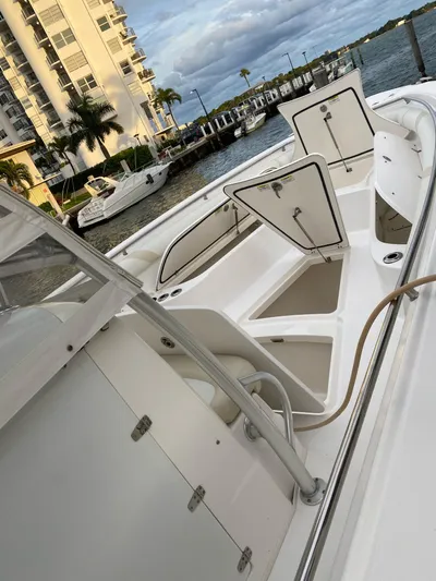  Yacht Photos Pics 2008 Boston Whaler 320 Outrage boat docked near waterfront buildings.