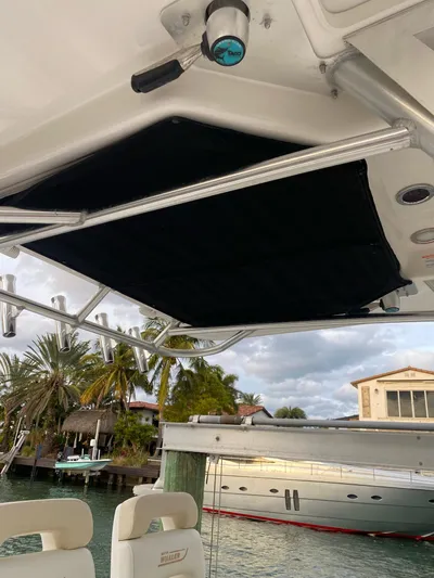  Yacht Photos Pics 2008 Boston Whaler 320 Outrage boat interior with rod holders and waterfront view.