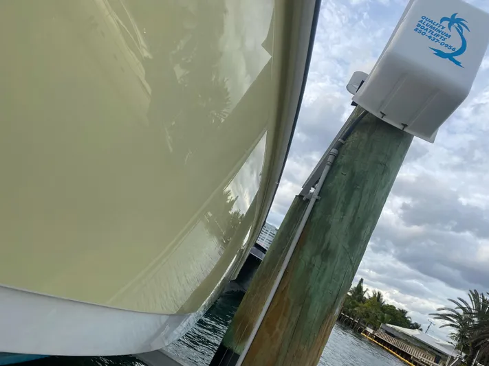  Yacht Photos Pics 2008 Boston Whaler 320 Outrage docked, side view with water and cloudy sky background.