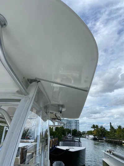  Yacht Photos Pics 2008 Boston Whaler 320 Outrage boat docked by a canal under a cloudy sky.