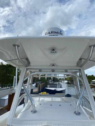  Yacht Photos Pics 2008 Boston Whaler 320 Outrage boat with Garmin equipment, docked under a cloudy sky.