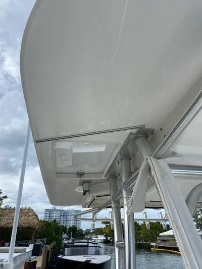  Yacht Photos Pics 2008 Boston Whaler 320 Outrage boat, view of the canopy and structure, docked near water.