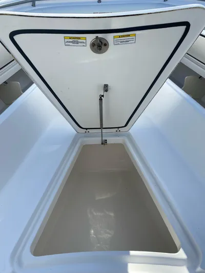  Yacht Photos Pics 2008 Boston Whaler 320 Outrage storage compartment open, showcasing spacious interior.