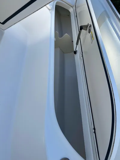  Yacht Photos Pics 2008 Boston Whaler 320 Outrage storage compartment, open and empty, showcasing interior space.