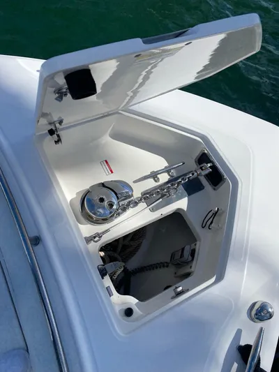 Yacht Photos Pics 2008 Boston Whaler 320 Outrage anchor locker with open hatch, showing anchor chain and winch.