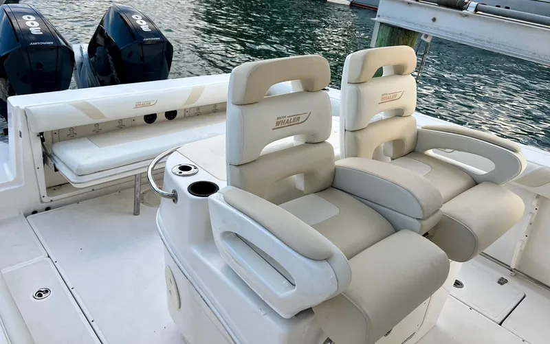  Yacht Photos Pics 2008 Boston Whaler 320 Outrage boat interior with dual cushioned seats and twin engines.