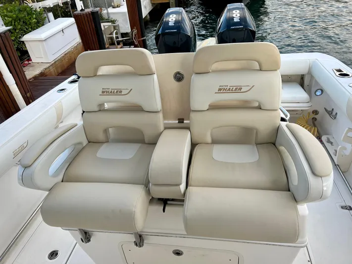  Yacht Photos Pics 2008 Boston Whaler 320 Outrage boat seats with dual outboard motors in background.