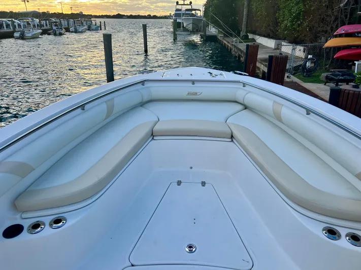  Yacht Photos Pics 2008 Boston Whaler 320 Outrage boat interior with cushioned seating at sunset.
