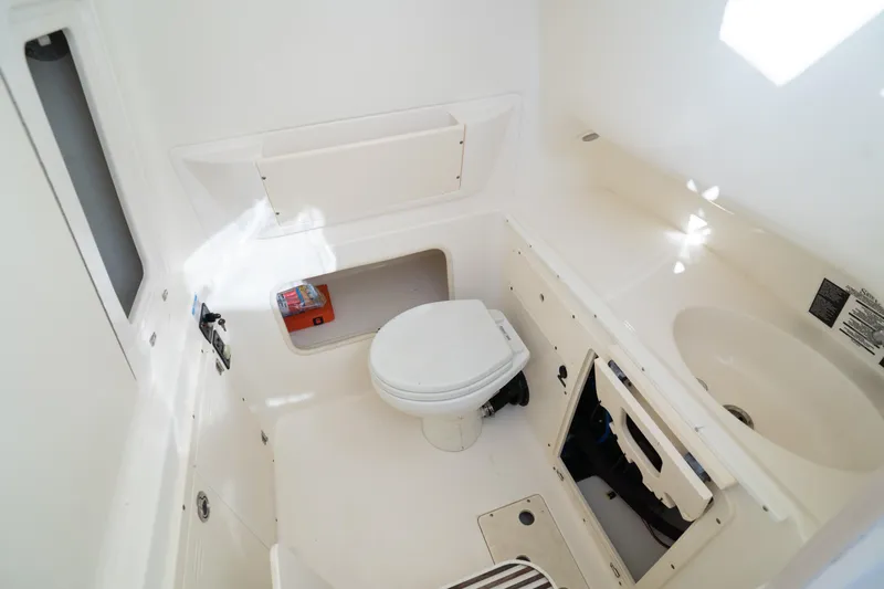  Yacht Photos Pics 2008 Boston Whaler 320 Outrage boat interior with toilet and sink.