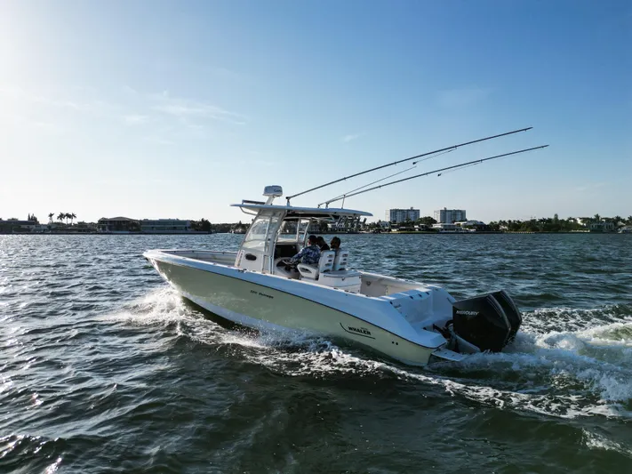  Yacht Photos Pics 2008 Boston Whaler 320 Outrage cruising on open water under clear skies.