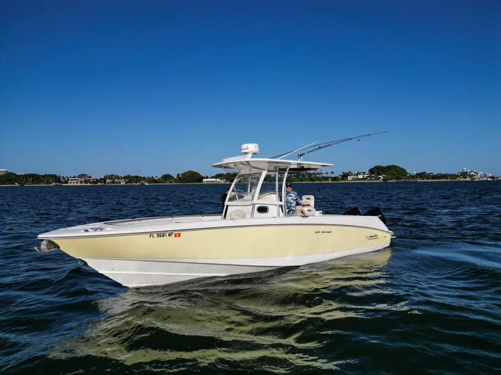  Yacht Photos Pics 2008 Boston Whaler 320 Outrage boat on calm water under clear blue sky.