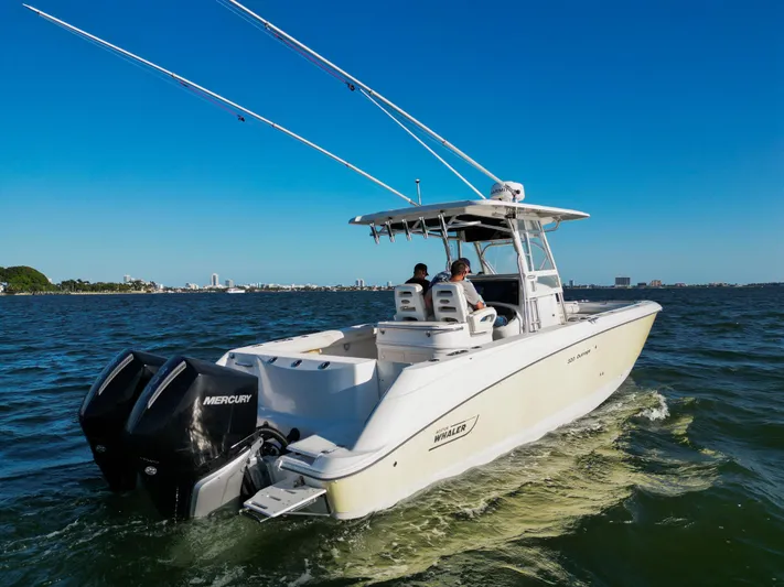  Yacht Photos Pics 2008 Boston Whaler 320 Outrage boat cruising on open water with dual Mercury engines.