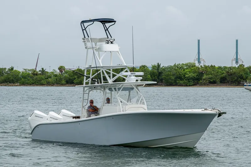  Yacht Photos Pics 2013 Yellowfin 39 Offshore boat cruising on a calm waterway.