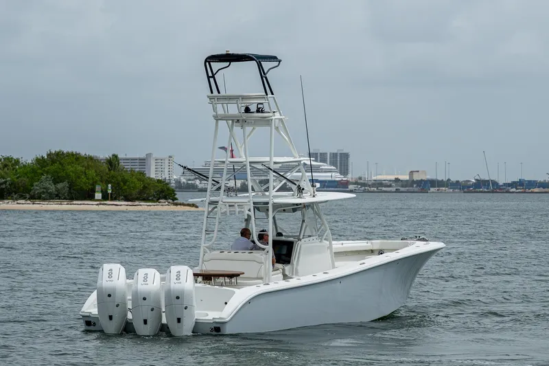  Yacht Photos Pics 2013 Yellowfin 39 Offshore boat with triple engines on the water.