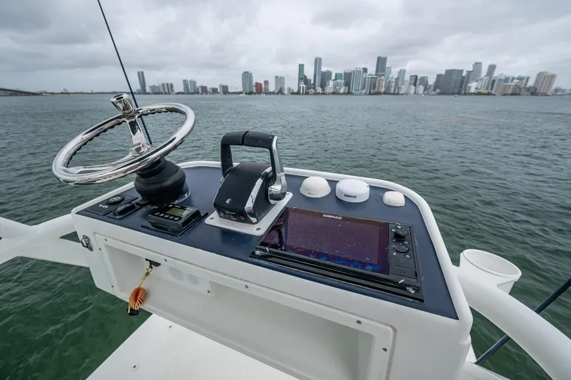 Yacht Photos Pics 2013 Yellowfin 39 Offshore boat helm with city skyline in background.