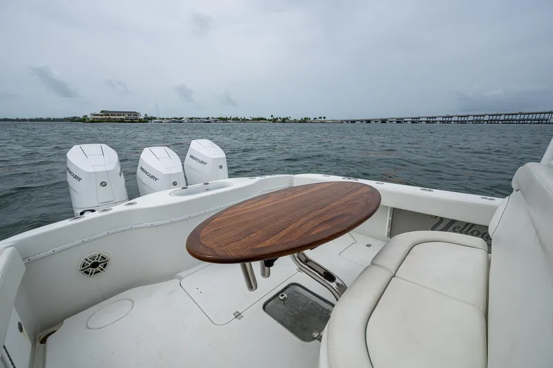  Yacht Photos Pics 2013 Yellowfin 39 Offshore boat with seating and table on open water.