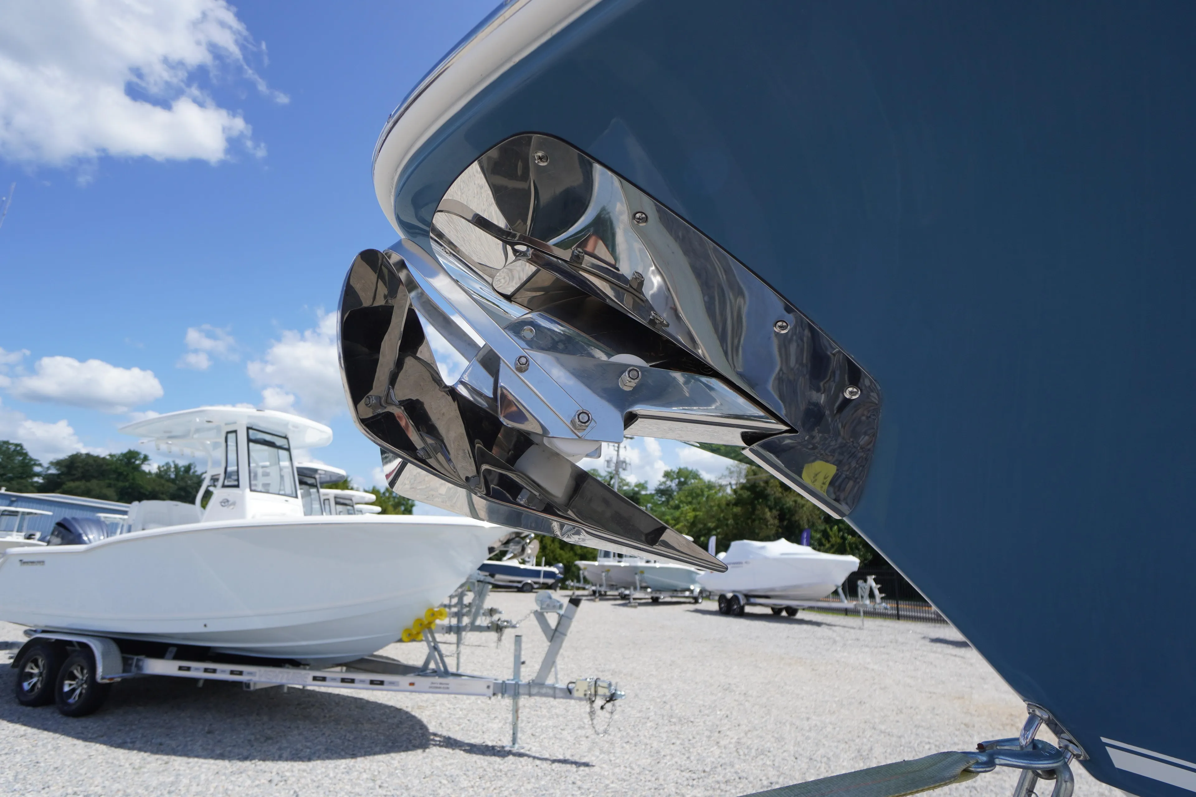 2026 Tidewater 232 LXF boat with stainless steel anchor, displayed outdoors on a sunny day.