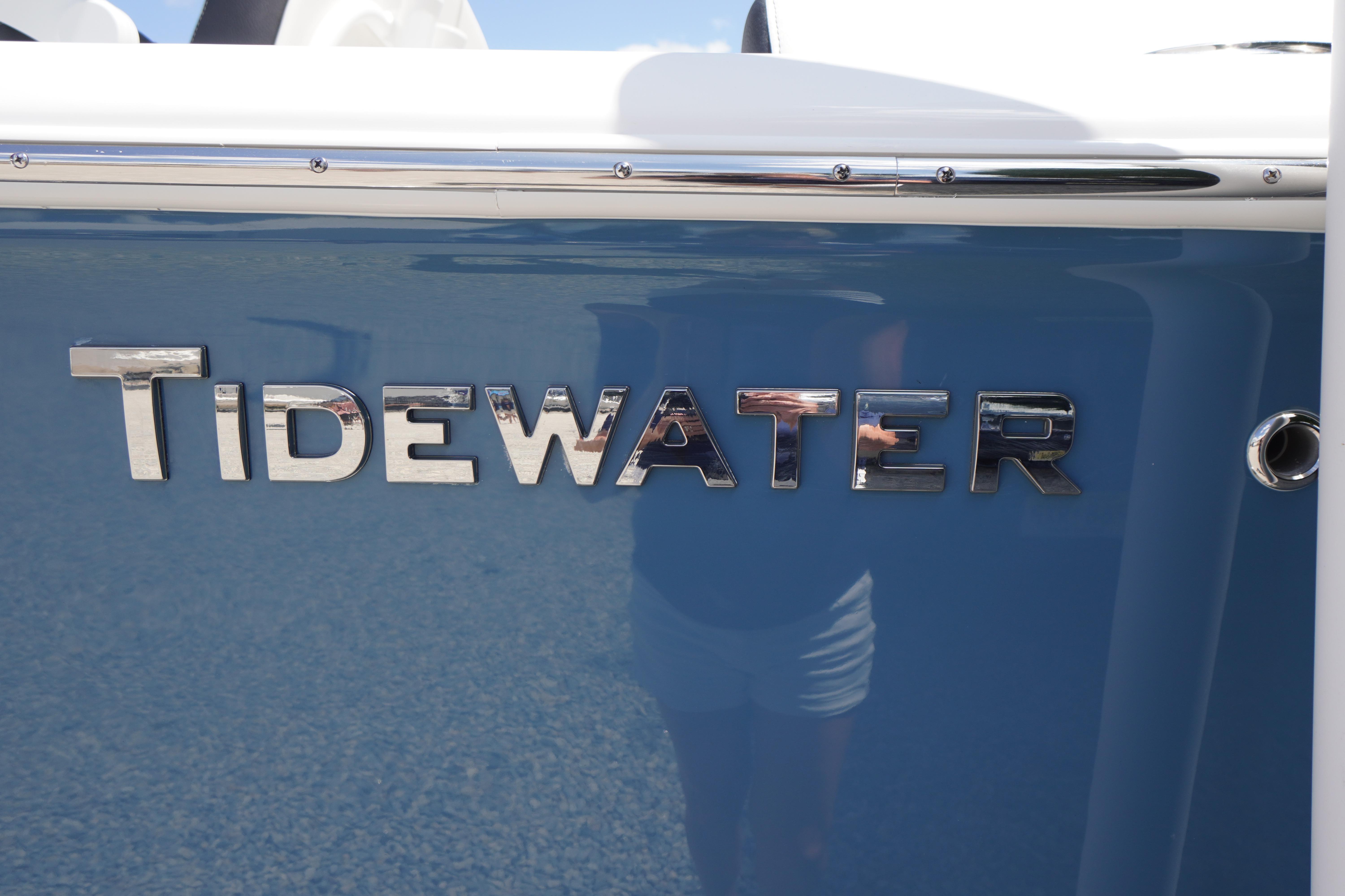 2026 Tidewater 232 LXF boat with chrome logo on blue hull.