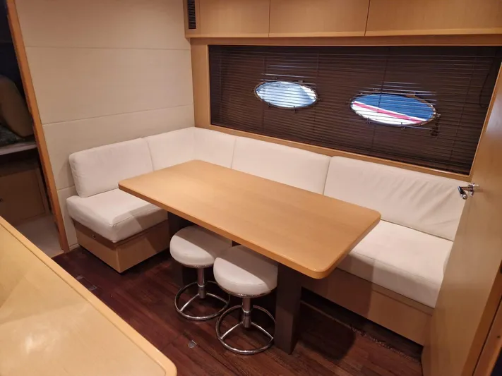  Yacht Photos Pics Luxurious interior of 2010 Princess V62 yacht with cozy dining area and modern furnishings.