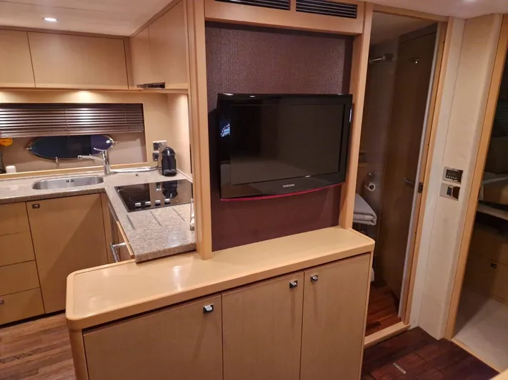  Yacht Photos Pics Luxurious interior of 2010 Princess V62 yacht with modern kitchen and TV.