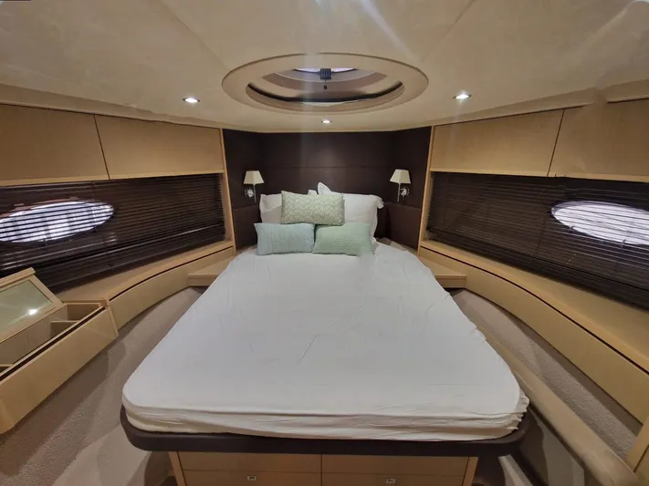  Yacht Photos Pics Luxurious bedroom interior of 2010 Princess V62 yacht with elegant bedding and ambient lighting.
