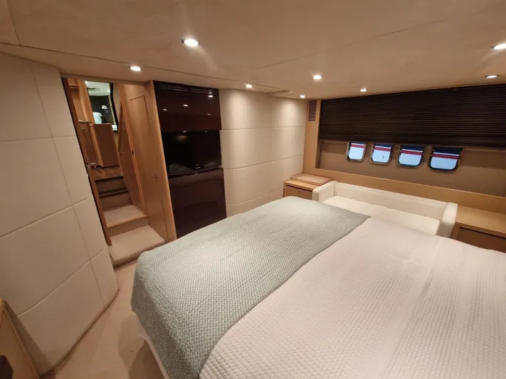  Yacht Photos Pics Luxurious cabin interior of 2010 Princess V62 yacht with cozy bed and modern design.