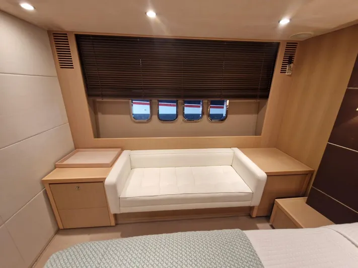  Yacht Photos Pics Luxurious interior of 2010 Princess V62 yacht with sofa and porthole windows.