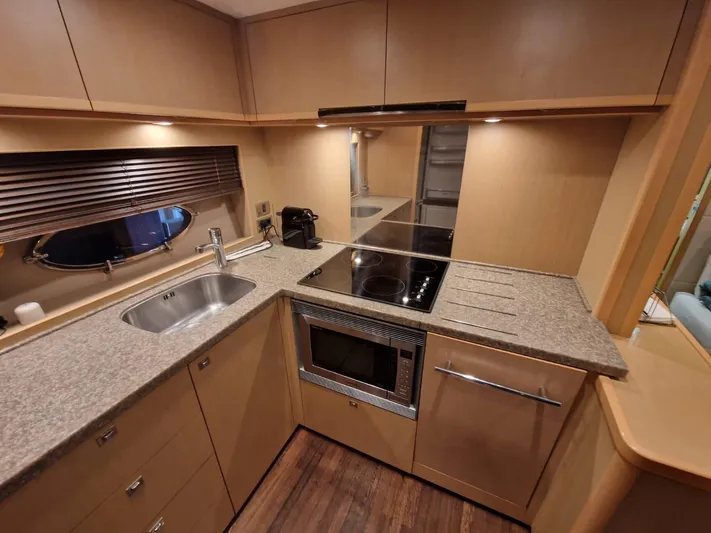  Yacht Photos Pics Luxurious kitchen interior of 2010 Princess V62 yacht with modern appliances and sleek design.