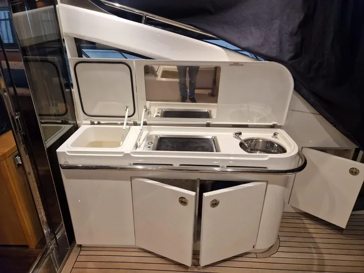  Yacht Photos Pics Outdoor kitchenette on 2010 Princess V62 yacht with sink and storage.