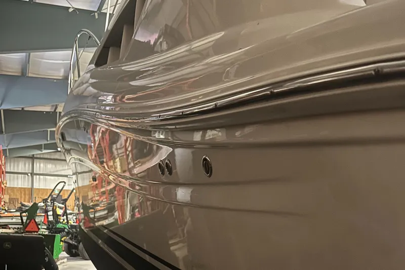  Yacht Photos Pics 2005 Sea Ray 390 Sundancer yacht in a storage facility, showcasing sleek hull design.