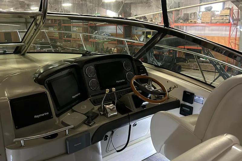  Yacht Photos Pics 2005 Sea Ray 390 Sundancer helm with Raymarine electronics and wooden steering wheel.