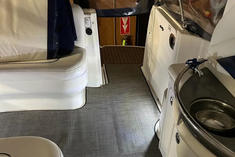  Yacht Photos Pics Interior of 2005 Sea Ray 390 Sundancer yacht, featuring seating and kitchenette area.