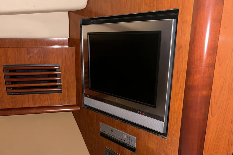  Yacht Photos Pics Flat-screen TV in 2005 Sea Ray 390 Sundancer yacht interior with wood paneling.