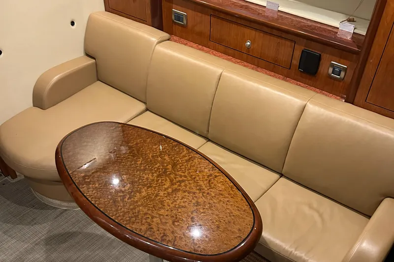  Yacht Photos Pics Luxurious interior of 2005 Sea Ray 390 Sundancer with leather seating and wooden table.
