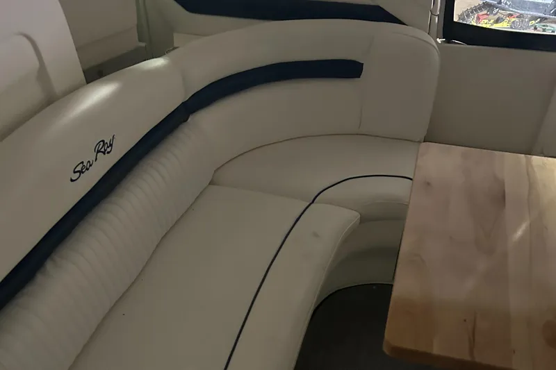  Yacht Photos Pics 2005 Sea Ray 390 Sundancer interior with white leather seating and wooden table.