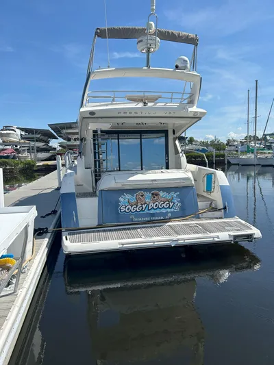  Yacht Photos Pics 2015 Prestige 450 Fly yacht docked, rear view with "Soggy Doggy II" nameplate.