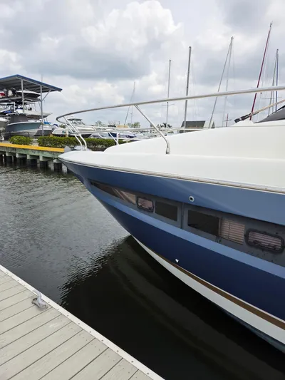  Yacht Photos Pics 2015 Prestige 450 Fly yacht docked at marina, cloudy sky background.