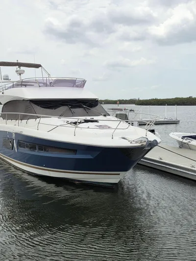  Yacht Photos Pics 2015 Prestige 450 Fly yacht docked at marina, overcast sky.