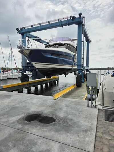  Yacht Photos Pics 2015 Prestige 450 Fly yacht on a lift at a marina dock.