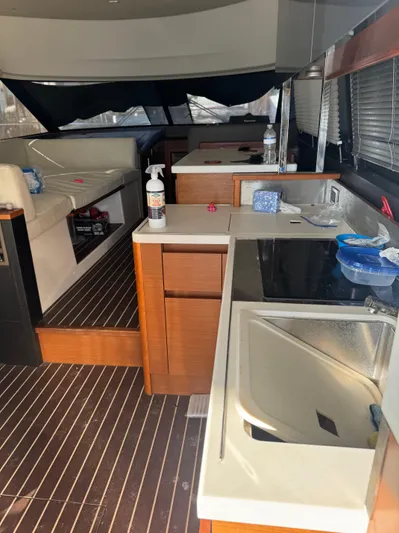  Yacht Photos Pics Interior of a 2015 Prestige 450 Fly yacht with modern kitchen and seating area.