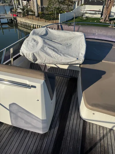  Yacht Photos Pics Flybridge of a 2015 Prestige 450 Fly yacht with covered seating area.