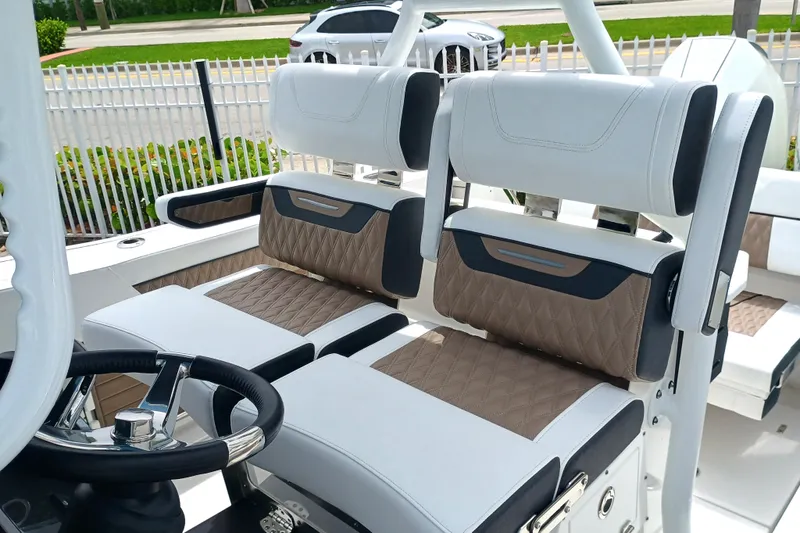 272-499 Yacht Photos Pics 2025 Blackfin 272 CC boat interior with stylish seating and modern steering wheel.