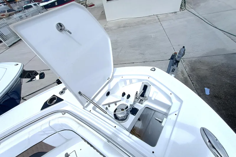 272-499 Yacht Photos Pics 2025 Blackfin 272 CC boat anchor compartment with open hatch, showcasing storage and equipment.