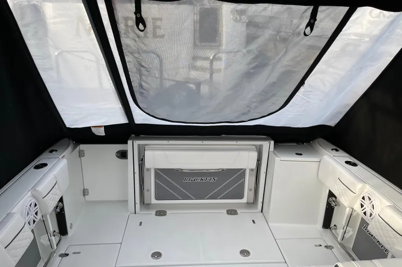 Yacht Photos Pics 2021 Blackfin 252DC boat interior with seating and storage compartments.