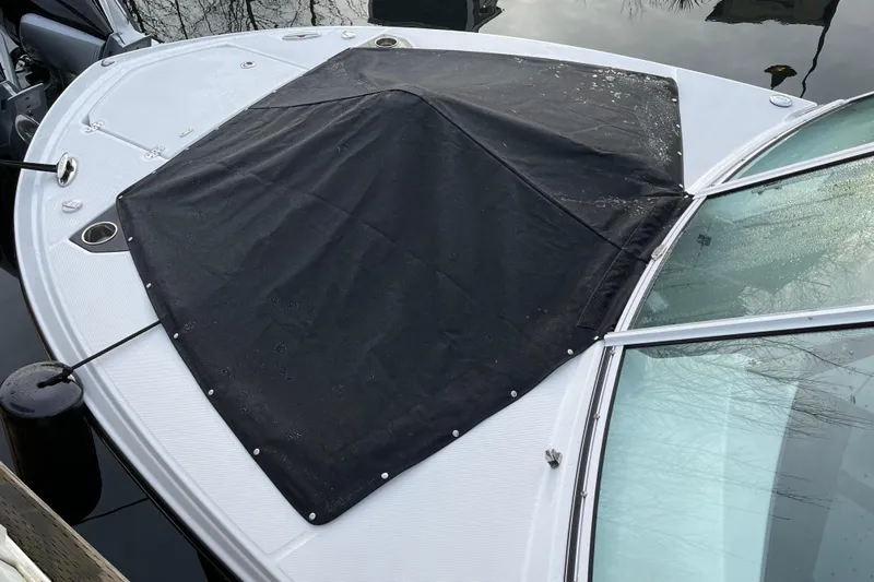  Yacht Photos Pics 2021 Blackfin 252DC boat with black cover on bow, docked on calm water.