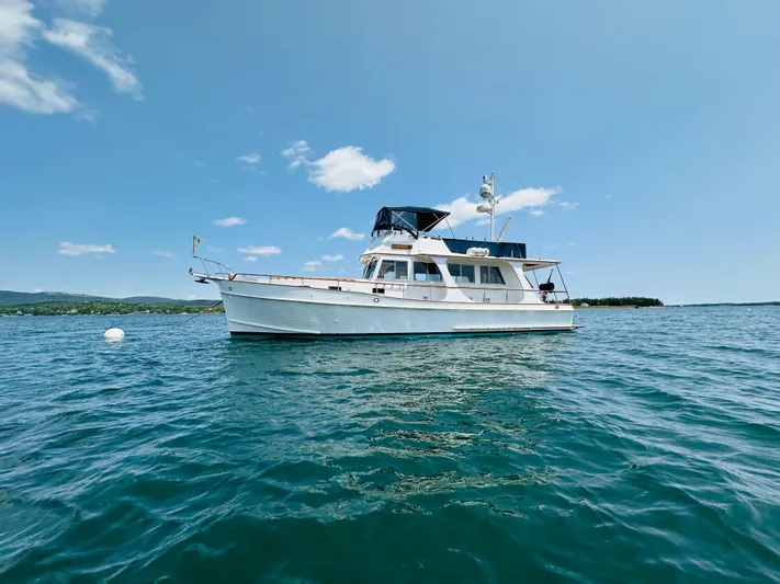 Liberty Yacht Photos Pics 2003 Grand Banks 46 Europa yacht on calm blue water under clear sky.